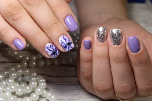 A closeup shot of female hands with a beautiful trendy art design manicure