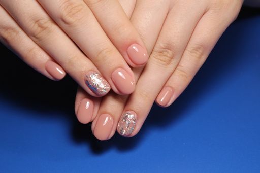 A closeup shot of female hands with a beautiful trendy art design manicure