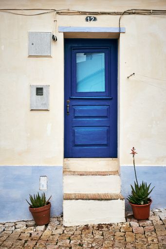 A  vertical shot of a blue door in Algarve - Southwest Portugal