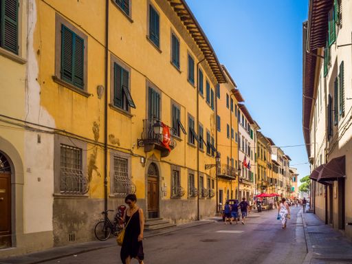 shopping street Corso Italia in the old town of Pisa with unidentified people. Pisa is known worldwide for its leaning tower