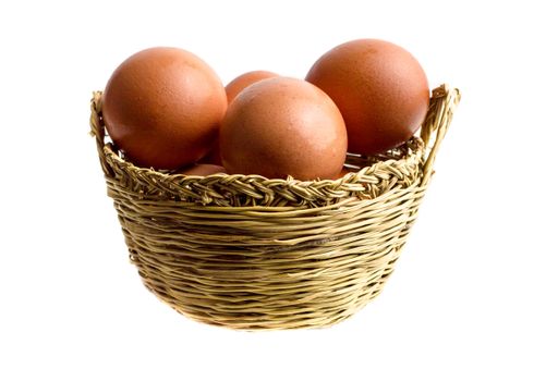 A closeup of fresh eggs in a basket, on a white background