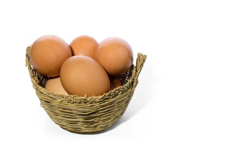 A closeup of fresh eggs in a basket, on a white background
