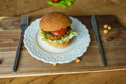 A delicious veggie burger on a wooden board