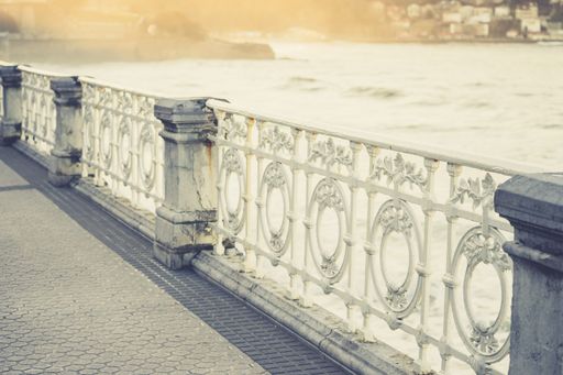 A closeup of the beautiful metallic fence on the bridge on the Beach of La Concha in Spain