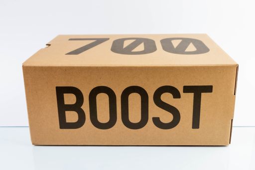 Adidas Yeezy boost 700 V2 Cream. Famous limited collection sneakers with box. Adidas running shoes isolated on a white background.