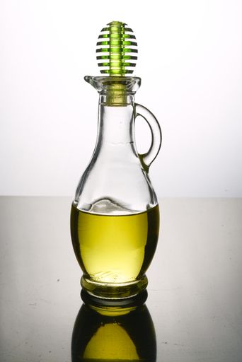 A vertical shot of oil decanter in backlight