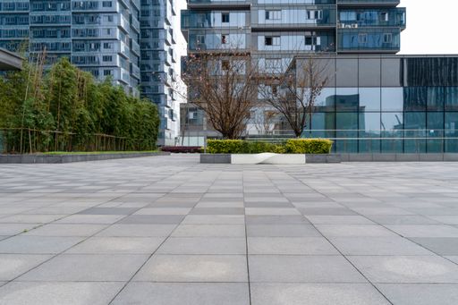 empty concrete ground floor with modern office building exterior in downtown.