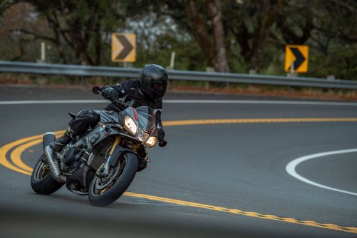 A person riding a motorcycle down a winding road.