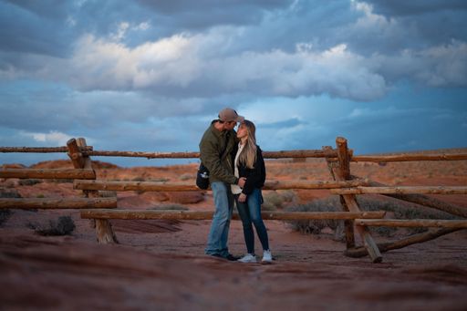 Session of a wedding couple looking at each other in the desert one evening at dusk