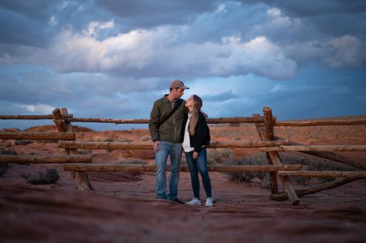 Session of a wedding couple looking at each other in the desert one evening at dusk
