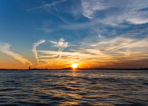 A beautiful view of a peaceful sea on a sunset sky background