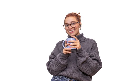 relaxed young redhead woman drinking from a cup