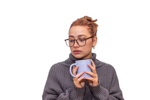 woman thinking young redhead drinking from a cup