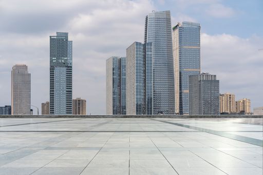 empty concrete square in front of modern cityscape with skyscrapers.