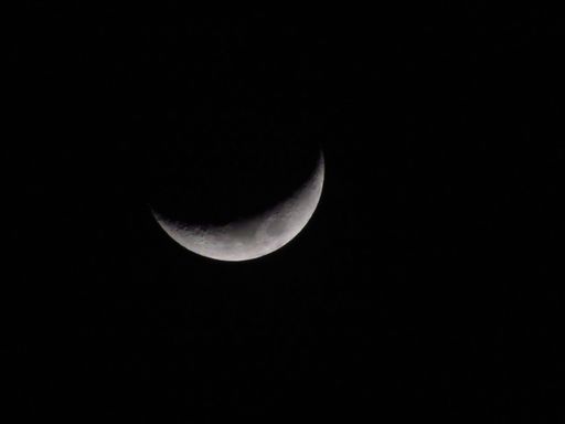 A beautiful landscape featuring a half-moon in the sky