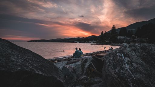 A beautiful shot of people resting at the beach at sunset
