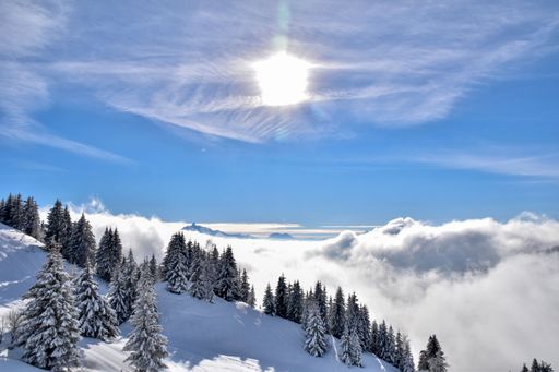 A stunning view of the snowy peaks of the Chamonix mountains in France, surrounded by white clouds
