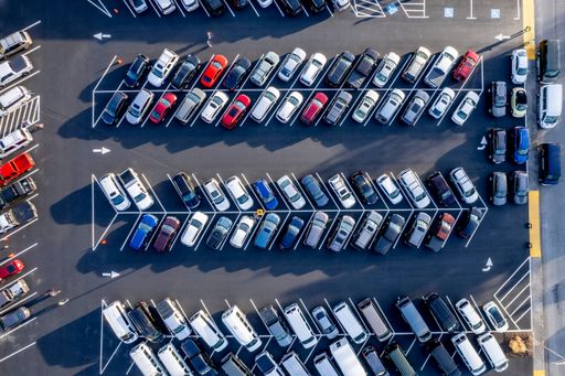Multiple vehicles parked in a deserted urban parking area