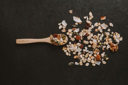 A healthy and delicious spooned muesli on a black background