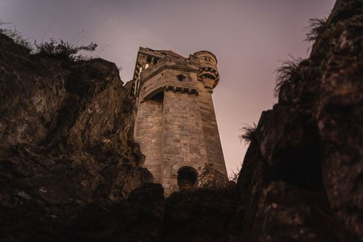 A low angle shot of a majestic castle illuminated by the warm morning light