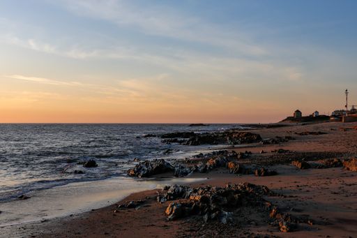 A beautiful quiet and calm beach during an orange sunset