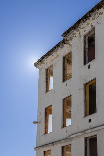 A high rise building with broken windows illuminated by daylight, Kristiansund, Norway