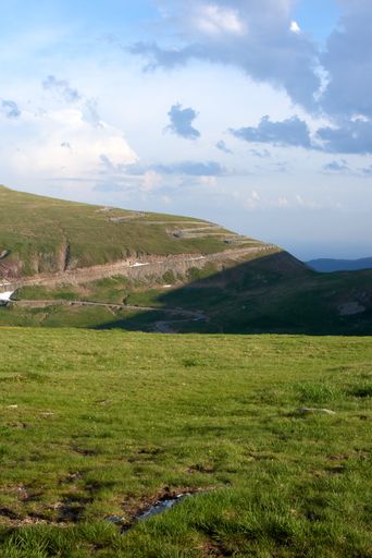 An aerial vertical view of a picturesque valley surrounded by lush green forest, Carpathian mountains