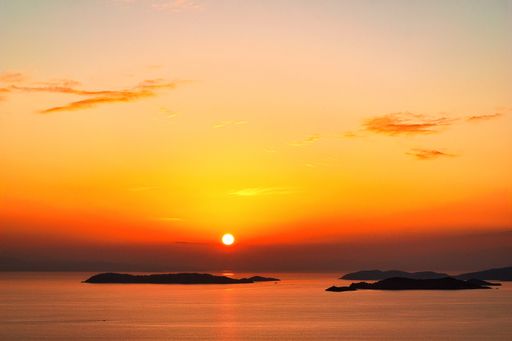 A landscape of the sea during a breathtaking red sunset in Skopelos Island, Greece