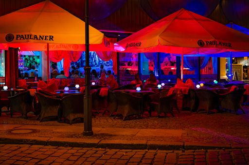 Berlin, Germany - August 3, 2019: Night shot of a colorfully illuminated restaurant in downtown Berlin.