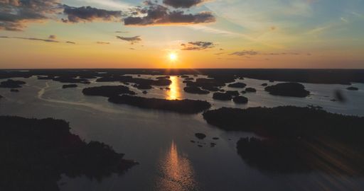 Aerial drone view of small islands, in the Finnish archipelago, on the Gulf of Finland, sunset, in Tammisaaren saaristo national park, in Uusimaa