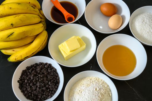 A closeup of bowls of baking ingredients for balking banana and chocolate cake