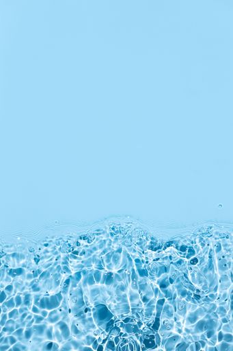 Bright Blue Abstract water background texture with ripples and waves. Copy space