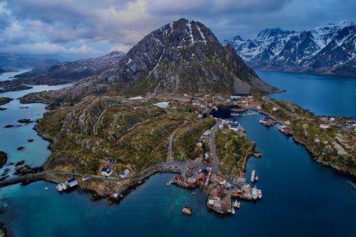 An aerial view of picturesque mountain town nestled near a majestic peak in Lofoten, Norway