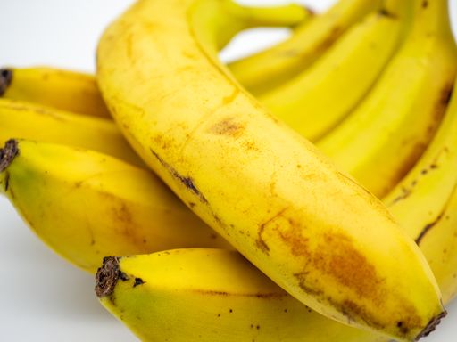 A closeup shot of ripe bananas on white background