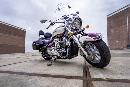 Suziki Intruder RT 1800 motorbike on display with shiny chrome parts at day time under a cloudy sky