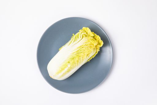 A top view of fresh chinese cabbage ​on the plate isolated on white background