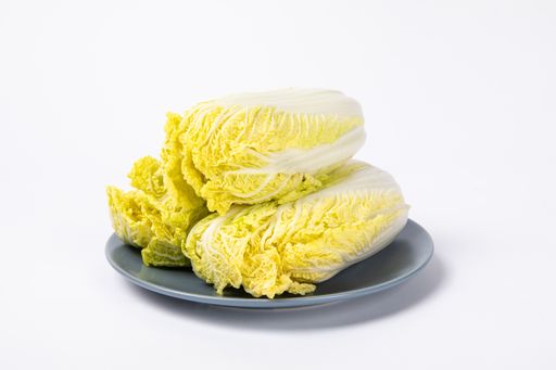 A closeup shot of fresh chinese cabbage ​on the plate isolated on white background