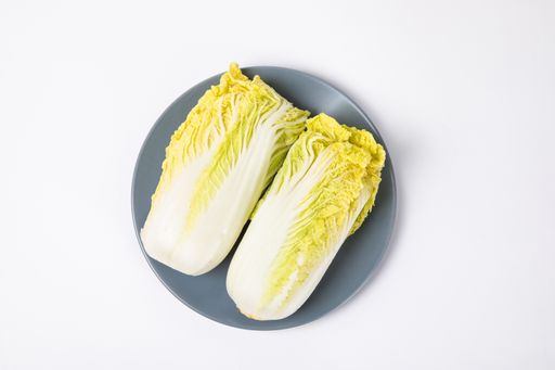 A top view of fresh chinese cabbage ​on the plate isolated on white background