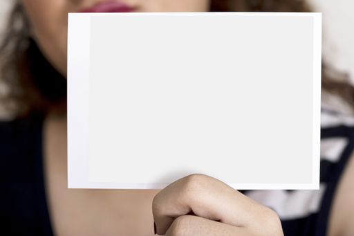 A young woman holding a sonography image in hand in front of her face, editable mock-up series template ready for your design