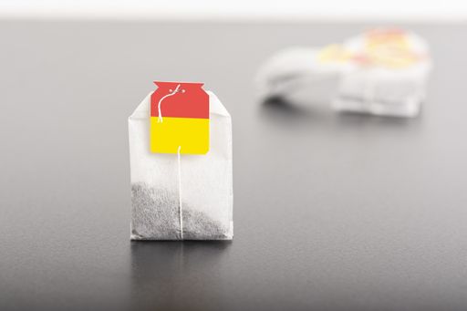 A porous teabag on dark table background, editable mock-up series template ready for your design