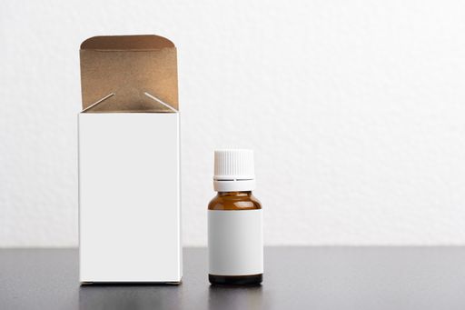 A child dietary supplement glass bottle with a package on gray background, editable mock-up series template ready for your design