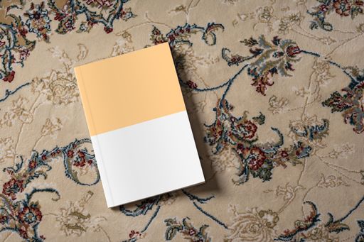 A storybook on a carpet with beautiful patterns, editable mock-up series ready for your design, book cover selection path included