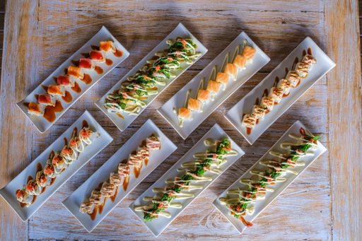 A high angle shot of different trays of sushi next to each other