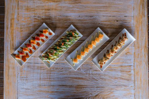 A high angle shot of different trays of sushi next to each other