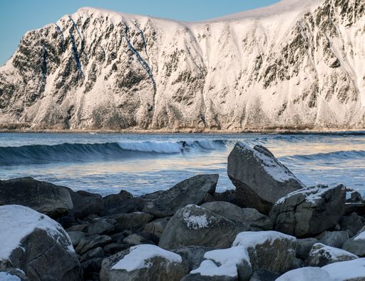 A lonely surfer in a sea, Lofoten islands, Norway