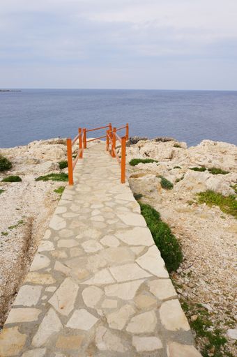 A vertical shot of a road leading to a sea in Cyprus