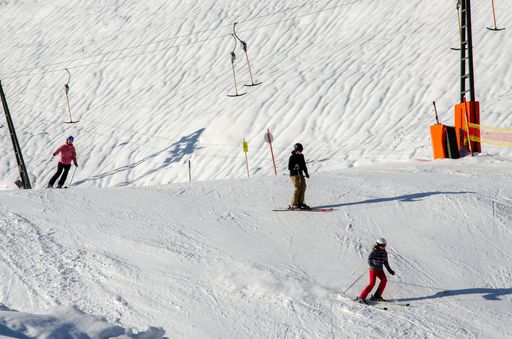A  closeup of a group of winter sports enthusiasts taking part in alpine skiing and snowboarding in Austria
