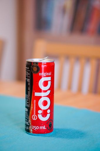 Open Original Cola coke in a can standing on table