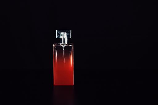 Elegant perfume bottle isolated on black background with copy space.