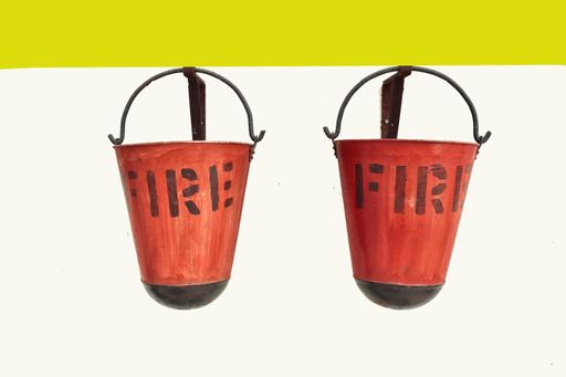 A closeup shot of two water buckets (fire safety equipment) on a wall